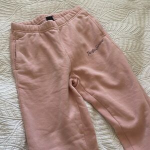 Pacsun pink sweatpants with purple lettering.